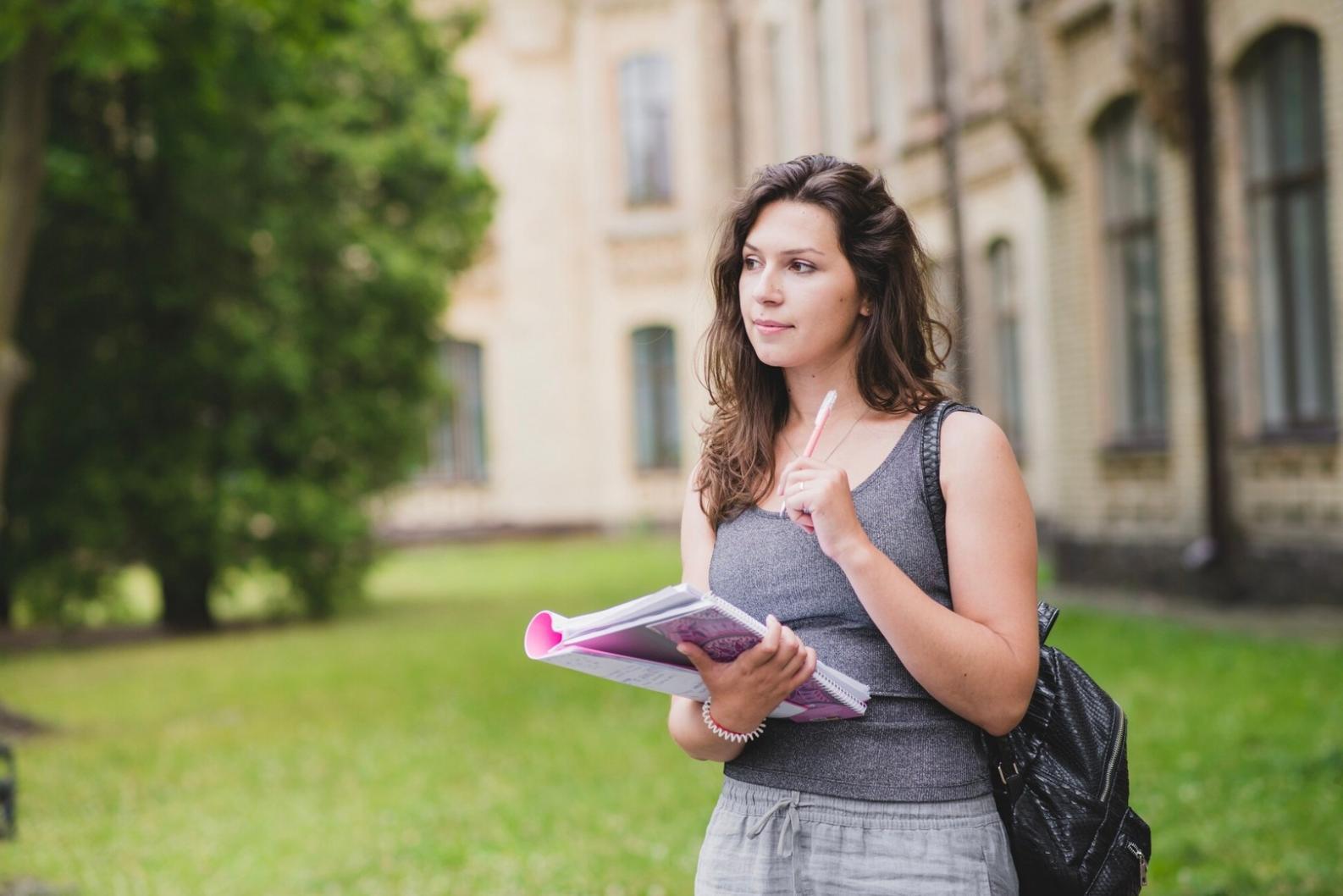 Student using budgeting tools on laptop with Australian currency and calculator nearby